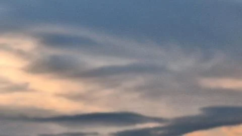 Abstract blurred sunset sky background with soft orange and blue pastel clouds 库存照片