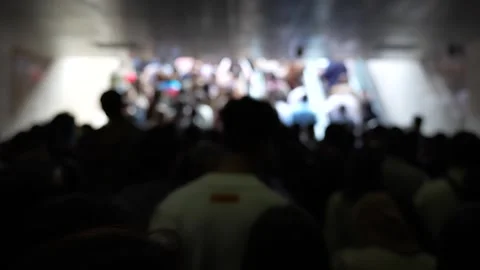 An abstract, blurred view of a large crowd of people moving towards a brigh.. Stock Footage 321301161