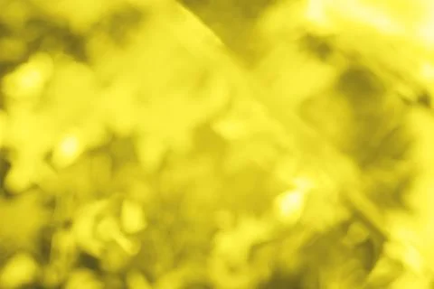 Abstract blurred yellow glitter background. Bright and colorful background. Stock Photos