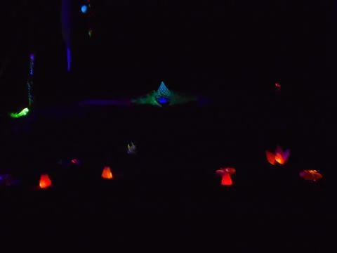 Abstract blurring light show of lanterns and rotating luminous conical web. Stock Photos