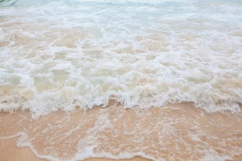 Abstract blurry background of soft wave of blue sea with sandy beach. Stock-Fotos