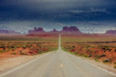 Abstract blurry background: view through the wet window Monument valley usa Stock Photos