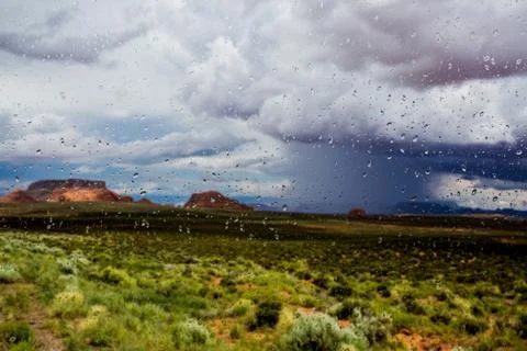 Abstract blurry background: view through the wet window Monument valley usa Stock Photos