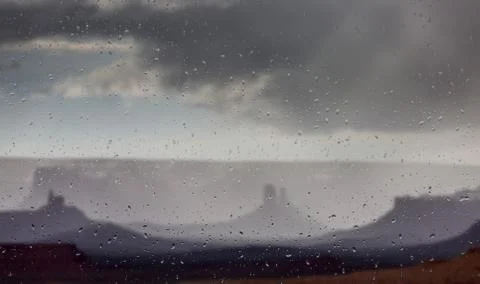 Abstract blurry background: view through the wet window Monument valley usa Stock Photos