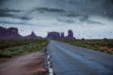 Abstract blurry background: view through the wet window Monument valley usa Stock Photos