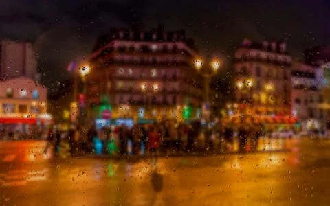 Abstract blurry background: view through the wet window Paris by Night Stock Photos