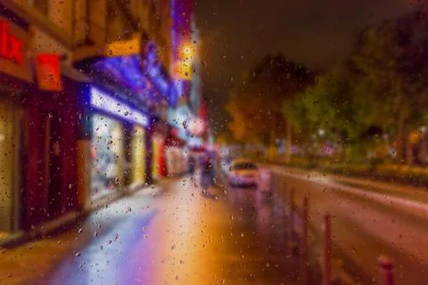 Abstract blurry background: view through the wet window Paris by Night Stock Photos