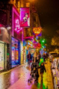 Abstract blurry background: view through the wet window Paris by Night Stock Photos