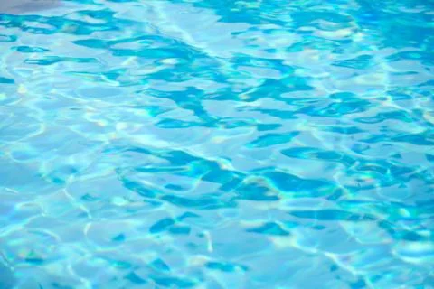 Abstract blurry background of water surface in swimming pool. Stock Photos