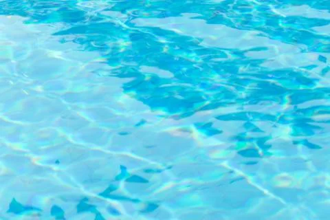 Abstract blurry background of water surface in swimming pool. Stock Photos