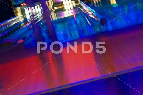 Abstract blurry bowling alley with a girl standing Stock Photos