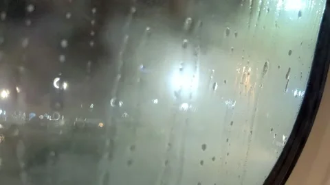 Abstract blurry view of airplane de-icing over from inside the cabin window. Stock Footage 194571329