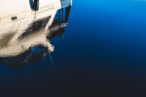 Abstract boat reflection on a deep blue dark harbor Stock Photos