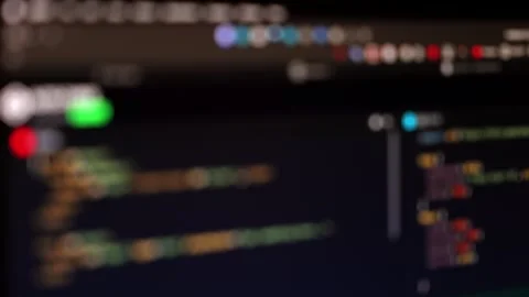 Abstract bokeh background of colorful programming code on a dark computer screen Stock Footage 320777583