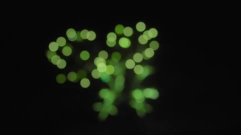 Abstract bokeh background of exploding green fireworks on a dark night sky Video stock 319802439