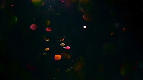 Abstract bokeh background shining gold particles. Glittering Particles Stock Footage 132823481