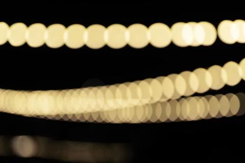 Abstract bokeh composition with warm golden light circles forming curved band Ilustração Stock