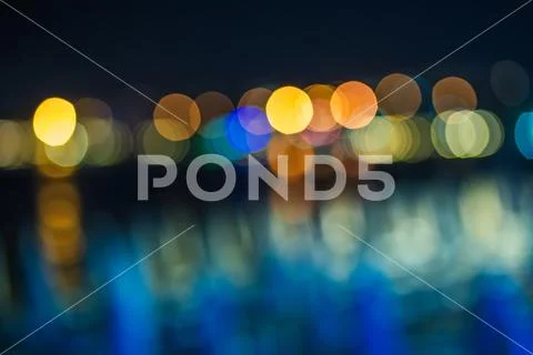 Abstract bokeh. Defocused lights of the night street. Blurred multicolored ci Stock Photos