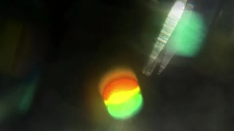 Abstract bokeh lights and lens flares transitioning in dark background with Stock Footage 343842087