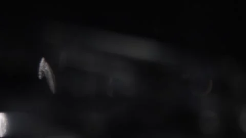 Abstract bokeh lights blurred background of white glowing light on black Stockbeeldmateriaal 318574136