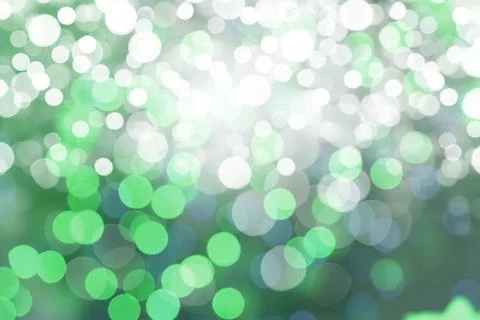 Abstract bokeh lights pattern is shimmering in flat design, with green white  Illustrazione stock