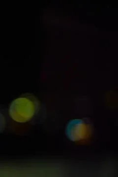 Abstract bokeh lights in various colors on black background 스톡 사진