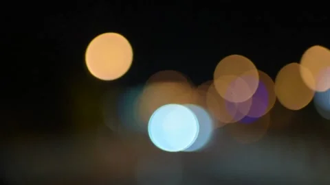 Abstract bokeh lights while driving on highway at night Stock Footage 175888910