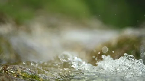 Abstract bokeh shot of a mountain stream in summer, slow motion Stock-Footage 288773182