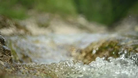 Abstract bokeh shot of a mountain stream in summer, slow motion Stock-Footage 288773186