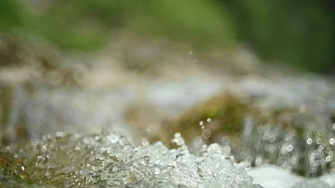 Abstract bokeh shot of a mountain stream in summer, slow motion Stock-Footage 288773188