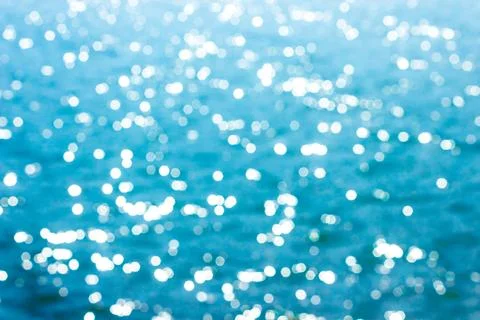 Abstract bokeh sunlight background with summer blue sea. Stock Photos