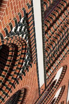 Abstract brick facade with striped arch details Stock Photos