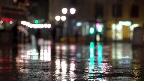 Abstract bright blurred background with raindrop, asphalt illuminated by street Stock Footage 78464802