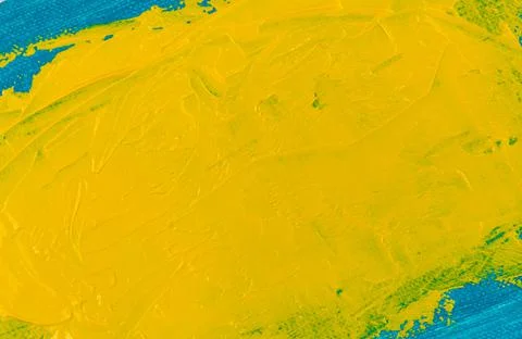 Abstract bright color background: flat wide spot of yellow paint on blue fabr Stock Photos