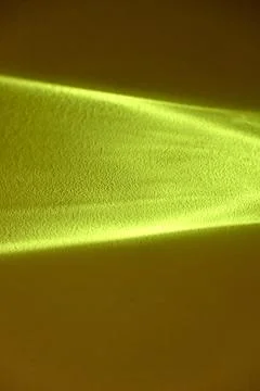 Abstract bright yellow light beam caustic pattern on a dark background Stock Photos