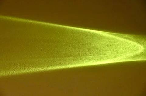 Abstract bright yellow light beam caustic pattern on a dark background Stock Photos