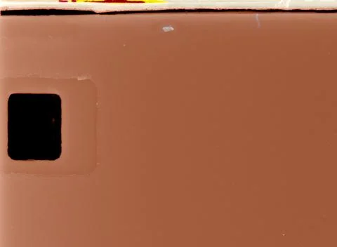 Abstract brown plastic surface showing square hole Stock Photos