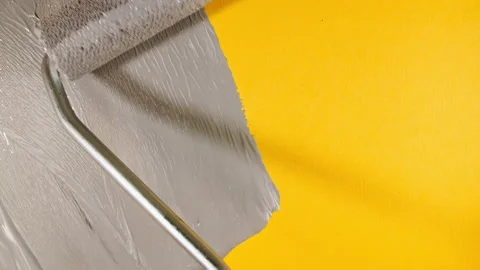 Abstract brushstrokes of gray paint brush, roller applied isolated on a yellow Video stock 166476904