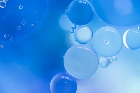 Abstract bubbles blue colored blurred background Stock Photos