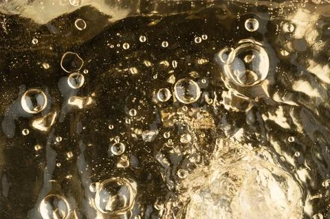 Abstract bubbles on liquid water yellow surface Stock Photos