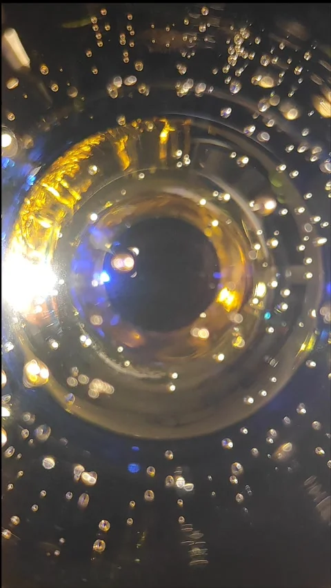 Abstract camera eye background from a glass of champagne Stock Footage 294760714