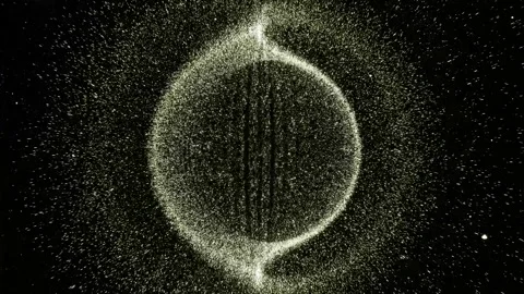 Abstract canvas from which small white elements spray. It spins and spins Stock Footage 297785232