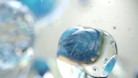 Abstract cells floating in clear liquid with blue particles. Stock Footage 342420528