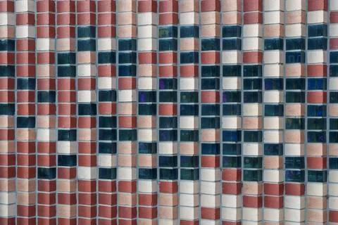 Abstract Checkerboard Wall Design Featuring Alternating Red, Beige Bricks a.. Stock Photos