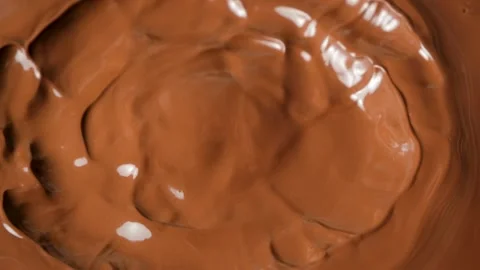 Abstract chocolate background with melted milk chocolate waves spreading outward Stock Footage 344869583
