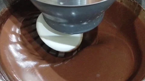 Abstract of chocolate cake batter being mixed in an electric mixer 스톡 동영상 142127359