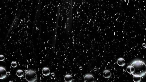 Abstract circle frame formed by floating water bubbles against a dark black Stock-Footage 346209312