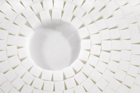Abstract circular pattern made from sugar cubes on white background Foto stock