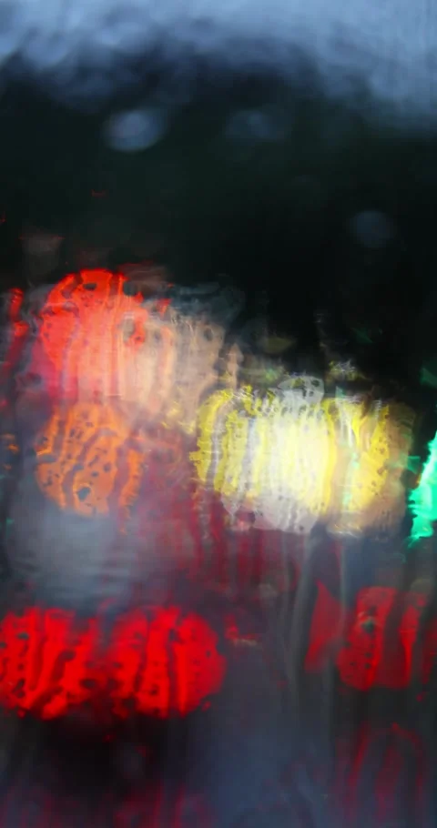 Abstract City Lights Glowing Through Rainy Window at Night Stock Footage 327689886
