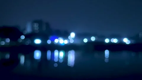 Abstract cityscape with blurred lights reflecting on water in a serene nigh.. Stock-Footage 340219820